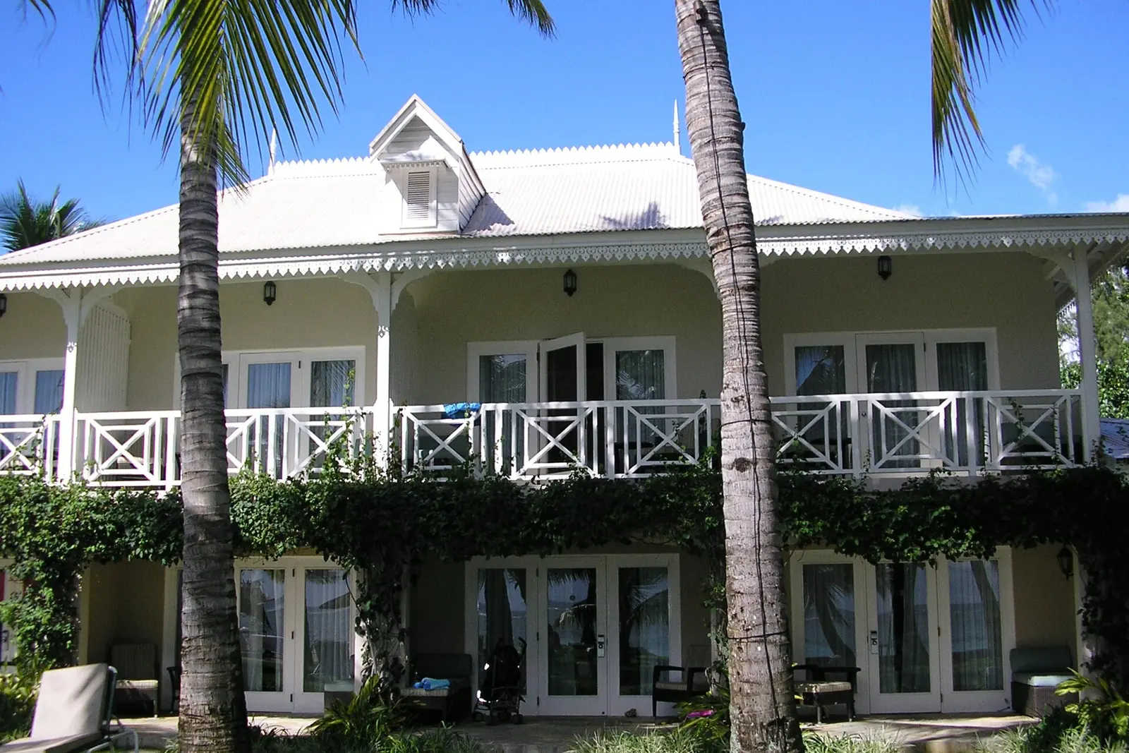 Colonial-style hotel residence framed by palms